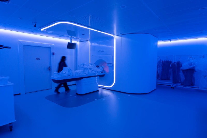 Image of a medical linear accelerator machine inside a brightly lit radiation therapy vault at Memorial Sloan Kettering Cancer Center.