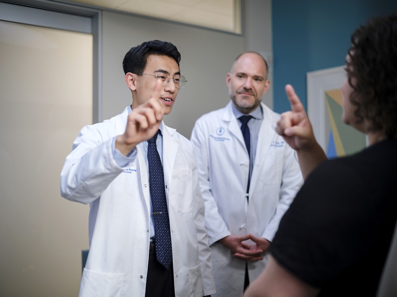 Dr. Brandon Imber (Associate Program Director) and Dr. Joshua Qian (Radiation Oncology Resident) perform a neurological exam on a patient. 