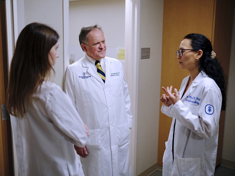 Dr. Simon Powell (Department Chairman) discusses a case with residents Dr. Boya Wang and Dr. Luiza Giuliani Schmitt. 