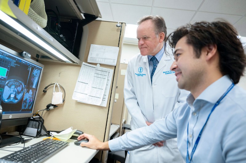 Radiation oncologist Dr. Simon Powell helps Dr. Gustav Cederquist complete breast cancer volumes using MIM software.