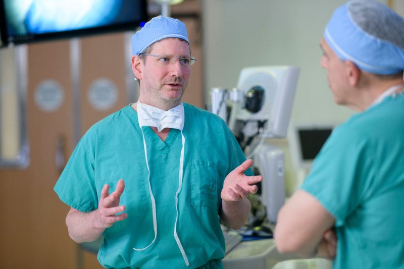 Neurosurgeon Cameron Brennan prepares in the operating room.