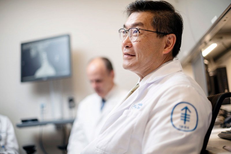 Radiation oncologist Josh Yamada in an office.