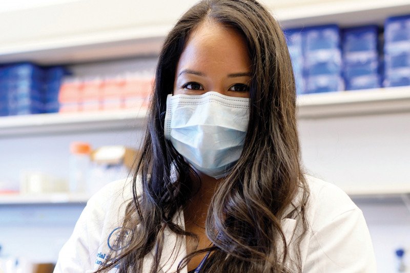 PhD candidate Laura Menocal wearing a mask in the lab