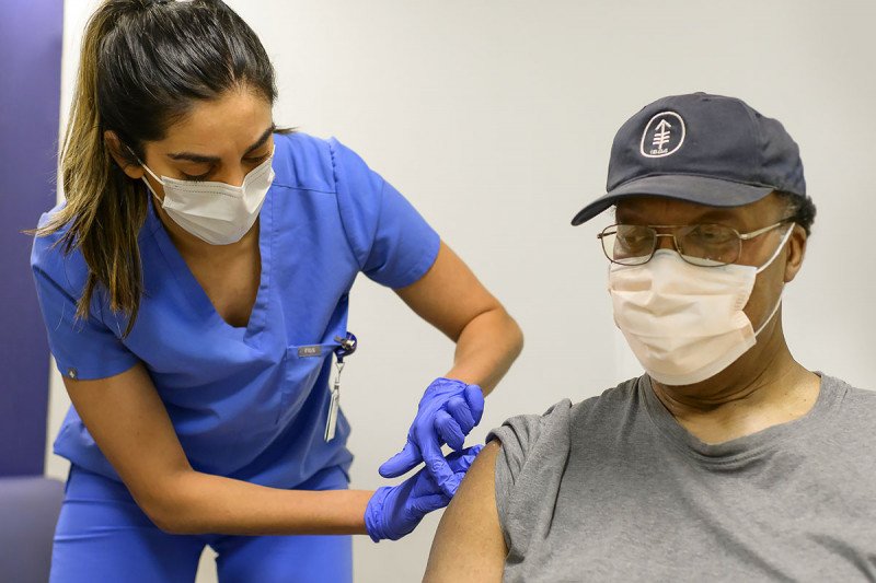 Woman vaccinates a patient