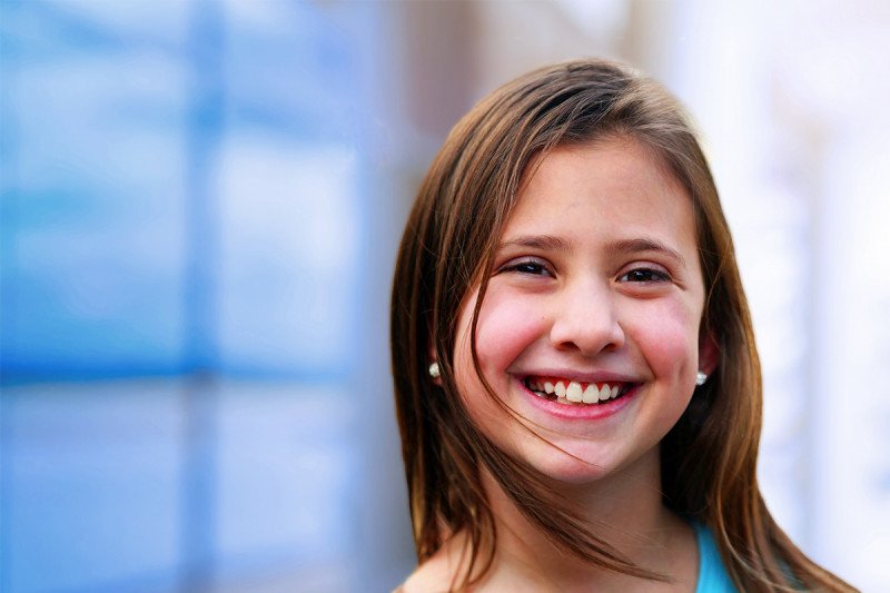 Young girl smiling at camera