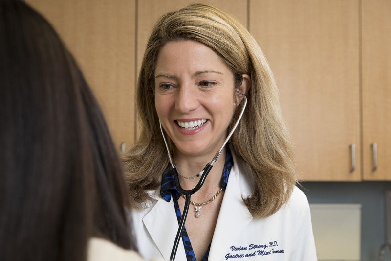 Smiling female doctor talking to patient. 