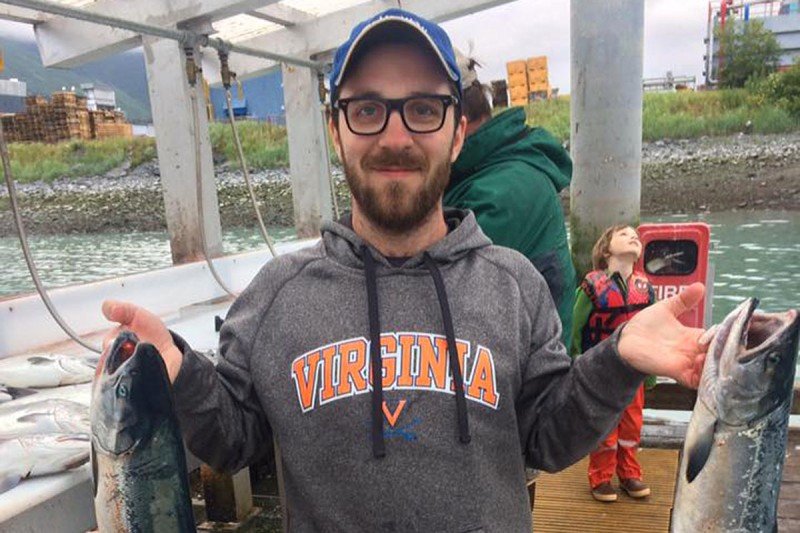 SKI immunologist Justin Perry holding a fish