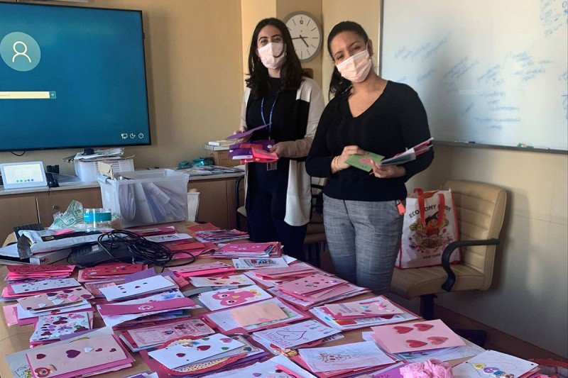Alexa Colon and Daniela Sierra standing behind a table full of cards
