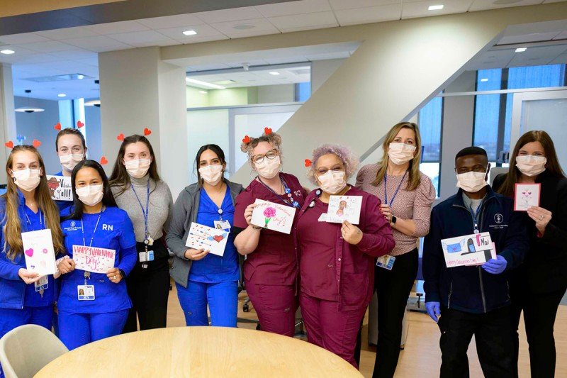 Group of staff holding cards
