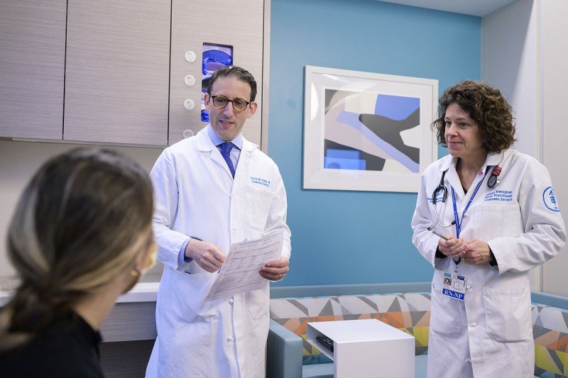 Hematologic oncologist Eytan Stein and nurse practitioner Coleen Ranaghan consult with a patient.