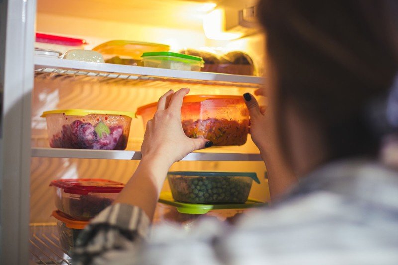 Person taking leftovers out of the refrigerator