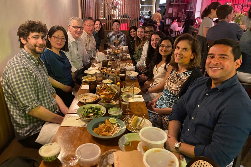 Fellows and faculty gathered around a table for a group dinner