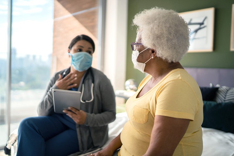 Elderly female patient talking to her doctor