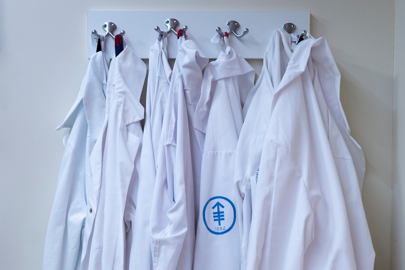 Laboratory coats hanging from pegs