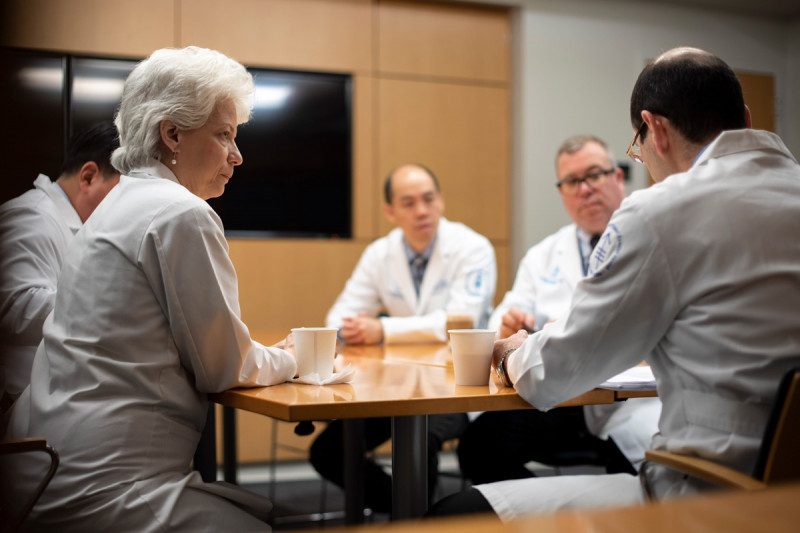 Urologic surgeon Machele Donat at a table with other physicians