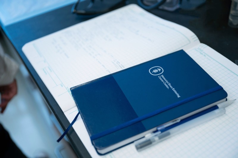 An MSK research notebook on a bench in a lab