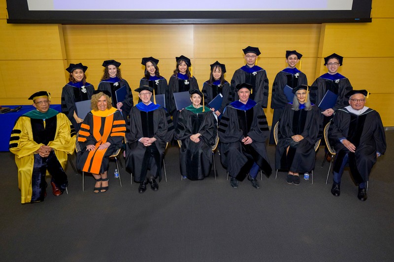 GSK PhD graduates with members of the platform party