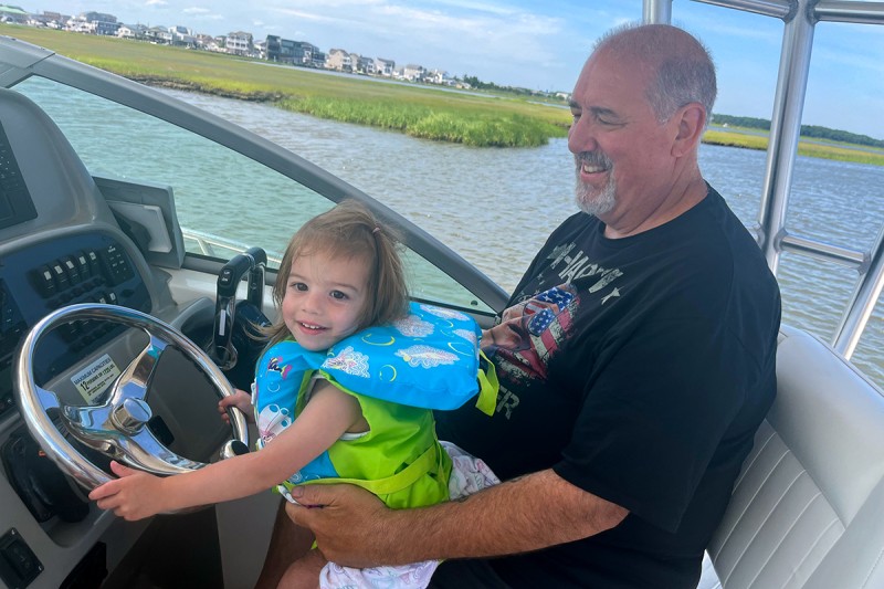 Michael with his granddaughter on a boat