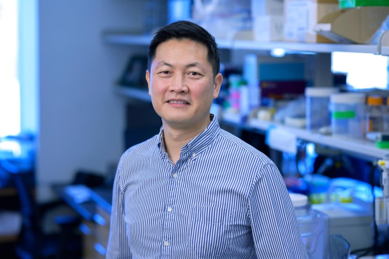 Dr. Wungki Park is seen smiling in a lab. 