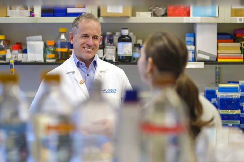 MSK Chief Scientific Officer Dr. Ross Levine smiles at a trainee in the lab 