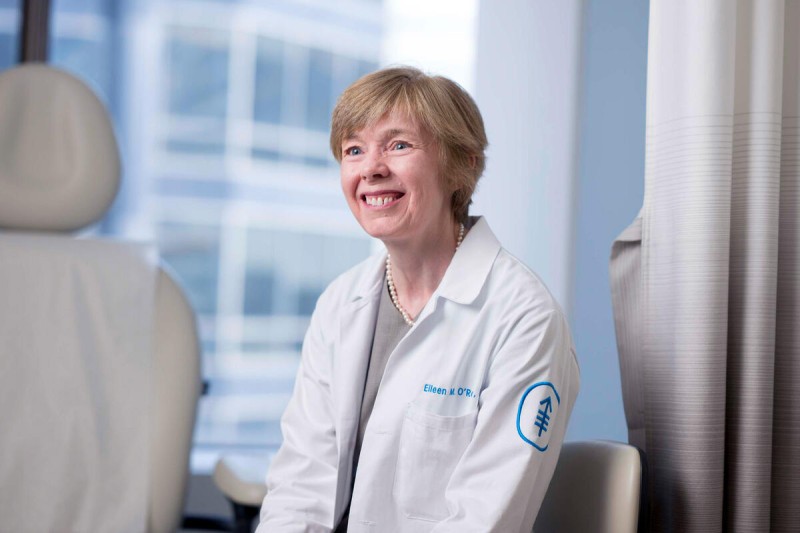 Dr. Eileen O'Reilly seen smiling in an exam room. 