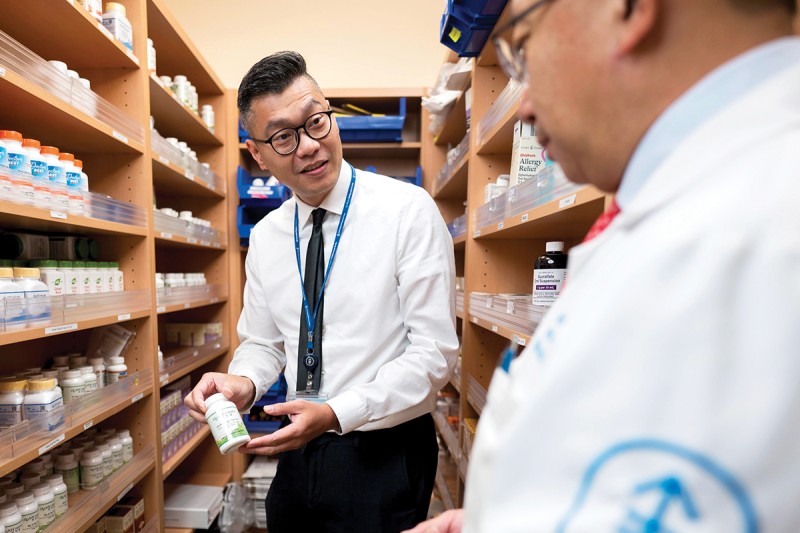 Dr. Jason Hou consults with Dr. Jun Mao inside MSK's herbal pharmacy 