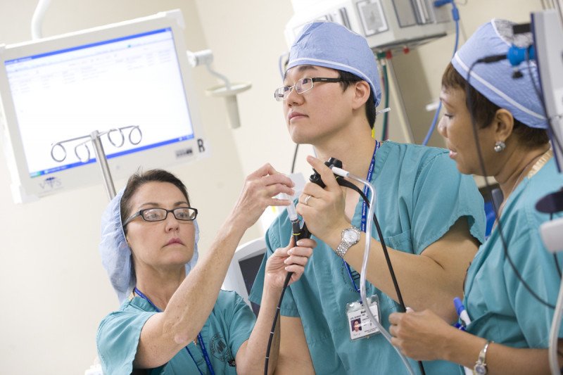 Pulmonologist Robert Lee performs an airway stent placement with two colleagues.