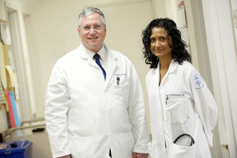 MSK hematologists Gerald Soff and Rekha Parameswaran stand together in lab coats.