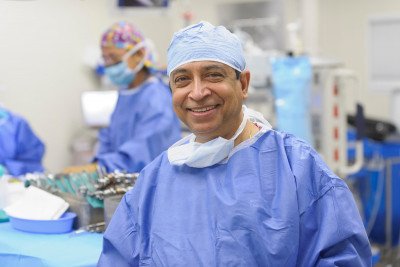MSK thyroid surgeon, Ashok Shaha, dressed in his scrubs smiling at the camera.