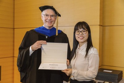 Postdoc Hui Yang accepts the 2018 Breakout Award from Charles Sawyers