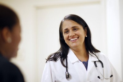 One of Memorial Sloan Kettering's experts in gastrointestinal neuroendocrine tumors, Monica Girotra, smiles to a patient.