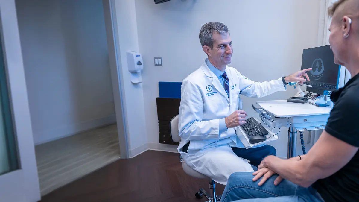 James Isbell, MD with a patient. 
