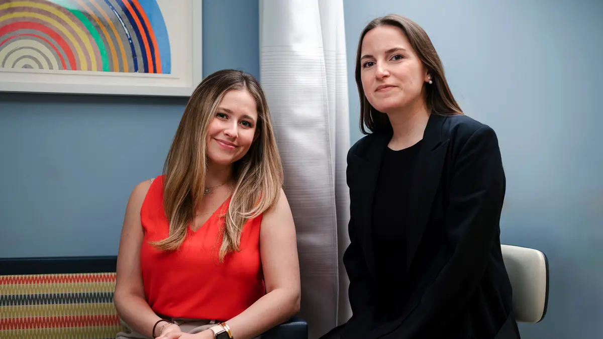 MSK social worker Hadley Maya, who supports young people with colorectal cancers, sits with a female patient. 