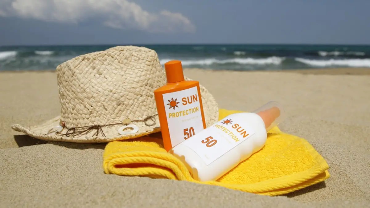 bottles of sunscreen on a beach