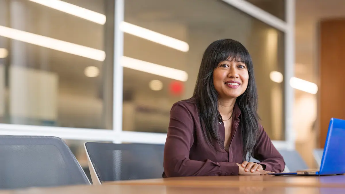 female employee sitting in office at table
