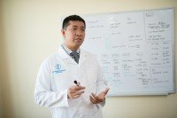 Physician standing in front of a whiteboard