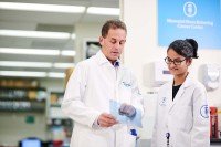 Physician-scientist Ross Levine and research technician Aishwarya Krishnan speak in the lab