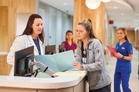 Two nurses talking at a desk