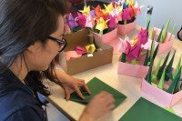 Vanessa Tran folding paper cranes
