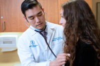 Cardiologist Anthony Yu examines a patient