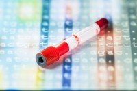blood tube laying atop DNA sequence