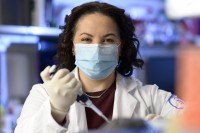 Physician-scientist Allison Betof Warner working in the lab.