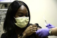 MSK Healthcare Hero rolls up their sleeve to receive the COVID-19 vaccine.