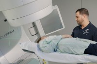 A patient in a linear accelerator at Memorial Sloan Kettering with radiation therapist Derek Fogelson.