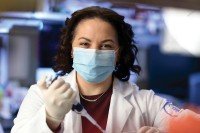 Allison Betof Warner uses a pipette in the lab