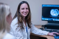 MSK gastroenterologist Robin Mendelsohn seen smiling at desk. 