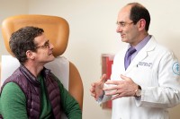 Urologic surgeon speaking with patient