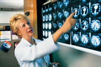 A doctor reviewing medical scans.