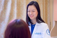 MSK breast medical oncologist Sherry Shen, MD, facing the camera and talking to a patient.