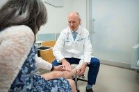 MSK orthopedic surgeon Dr. Jonathan Forsberg examines a patient's leg 